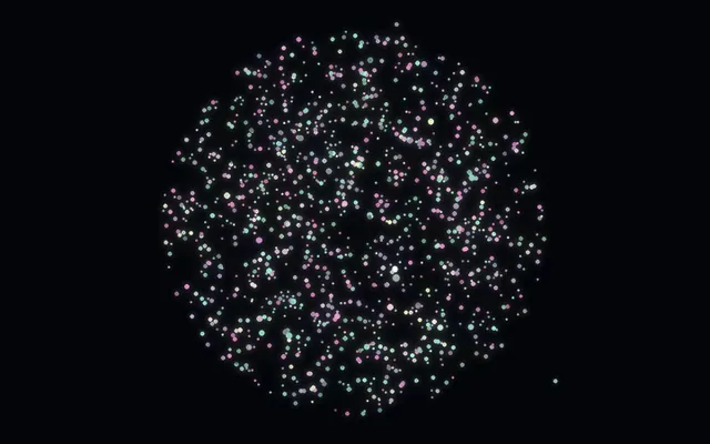 An animated view of a rotating galaxy of coloured specks coalescing into a handful of larger planets, drawn with motion trails.